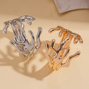 Exaggerated irregular geometric metal cuff bracelet in polished gold and silver finishes