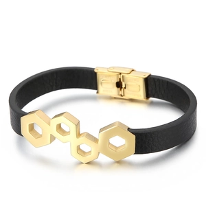 Black leather woven bracelet with golden hexagonal stainless steel plates on white background