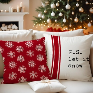 Detail of red snowflake and 'let it snow' linen pillow covers in Christmas home setting