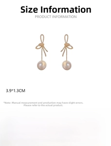 Detail showing knot earrings with white pearls and sparkling pavé crystals, 3.9x1.3cm size