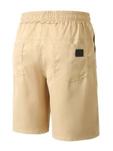 Detail of khaki men's summer shorts showing elastic waistband and back pockets structure