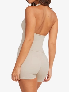 Detail of beige halter backless yoga bodysuit showing slim fit and smooth fabric