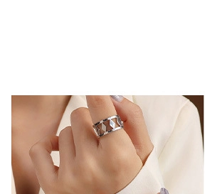 Detail of silver geometric hollow rhombus ring on finger with modern minimalist design