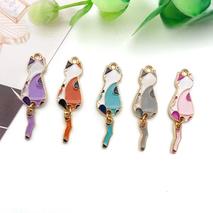 Detailed view of colorful enamel cat pendants with movable tails for DIY jewelry making