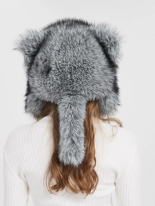 Detail showing plush faux fur texture and long tail design on a silver gradient hood