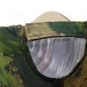 Macro view of camouflage baseball cap with adjustable Velcro strap and canvas fabric texture