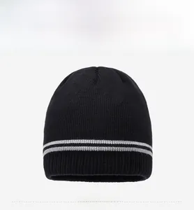 Detailed front view of black knit beanie with gray stripes and FBQE brand patch