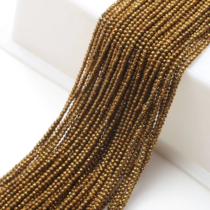 Detailed view of faceted glass beads in antique gold finish for DIY jewelry crafting
