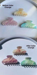 Macro detail of large color-changing acrylic hair claws with marble texture in 3 colors
