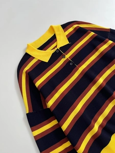 Detail view of the striped knit Polo sweater with navy, yellow, and orange-brown textures