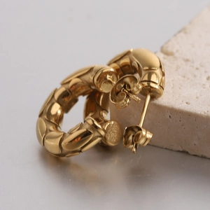 Close-up of 18K gold-plated C-shaped earrings with 5mm embossed snake texture details