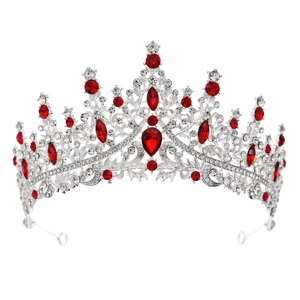 Detail of silver bridal crown featuring red teardrop gemstones and sparkling rhinestones