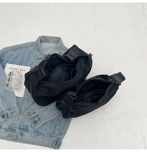 Black Oxford cloth dumpling bags in large and small sizes on denim background
