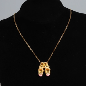 Detail of gold ballet slipper pendant with pink tips and crystals on O-chain