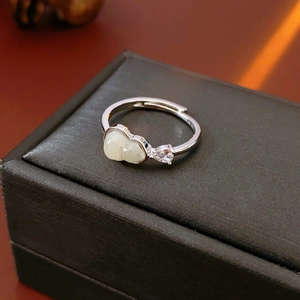 Macro detail of adjustable silver ring with beige jade stone and waterdrop zircon inlay