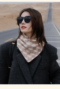 Detailed view of fashionable geometric monogram scarf worn by a model on a desert road