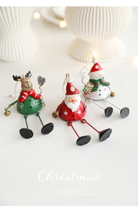 Three metal Christmas bell ornaments featuring Santa, reindeer, and snowman designs