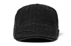 Detail view of black washed cotton newsboy cap featuring vertical wave stitching craftsmanship