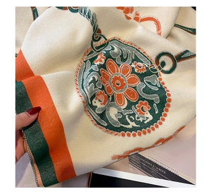 Close-up of thick twill cashmere-like scarf with vintage floral pattern and stripes