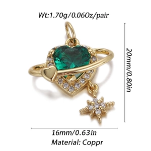 Detail view of golden heart planet pendant with green stone and star drop on white background