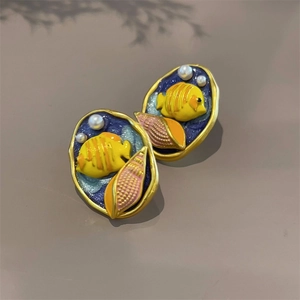 Detail of marine earrings with enamel tropical fish pink seashell and small pearls
