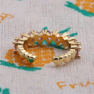 Adjustable gold plated open ring featuring pink heart-shaped cubic zirconia stones