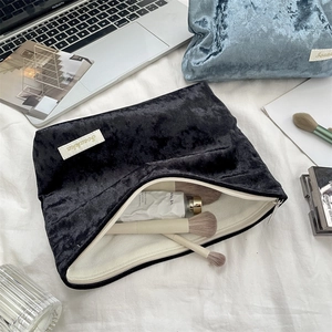 Macro view of black velvet cosmetic bag with zipper and large capacity for brushes