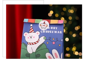 Close-up of Christmas gift bags with festive bear illustrations and seal stickers