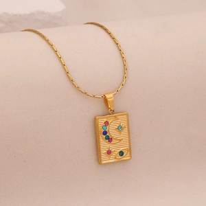 Detail of gold moon star pendant with blue pink crystals on stainless steel chain
