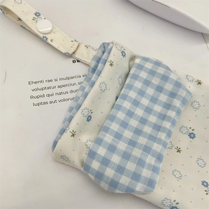 Detail of floral and plaid canvas nurse pocket protector with button closure