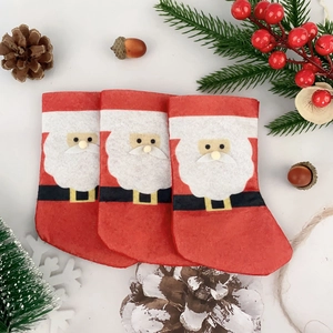 Three mini felt Christmas stockings with Santa Claus appliques for cutlery or tree decor