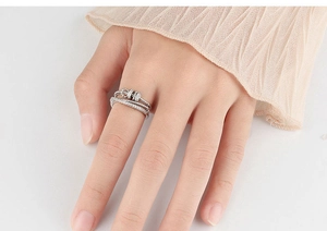 Close-up of adjustable silver snowflake ring with zircons on a model's finger