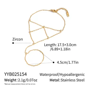 Macro shot of 18K gold plated mesh finger bracelet with zircon inlay on white background