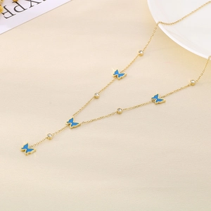 Detail of gold Y-chain necklace featuring blue butterfly charms and round zircon accents