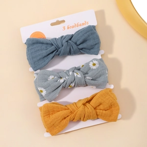 Three-pack floral baby headbands featuring bows in navy, yellow, and daisy patterns