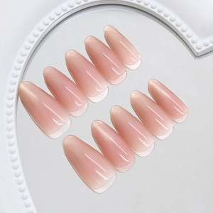 Pink cat eye gradient press-on nails in long almond shape with shimmer finish