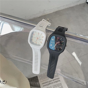 Flat lay of black and white square silicone sports watches with colorful numeric dials