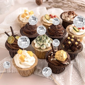 Detailed view of silver disco mirror ball cake toppers on wooden sticks for parties