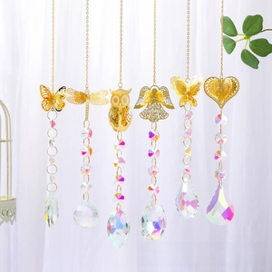 Detailed view of golden metal animal suncatchers with sparkling AB crystal prism beads