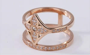 Macro shot of rose gold double-layer ring with sparkling flower motif and zircon inlay
