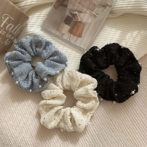 Three elegant tweed scrunchies in blue, beige, and black with pearls for women's hair