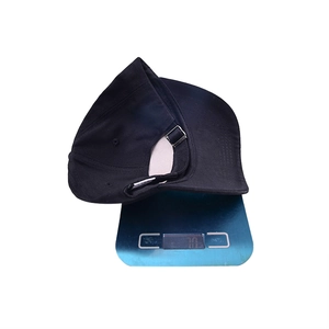 Top view of a black cotton baseball cap on a blue digital scale showing 70g weight