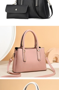 Close-up of pebble leather handbags in pink and black with metal charms and straps