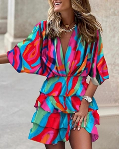 Detail of deep V-neck and vibrant abstract print on fall batwing sleeve dress