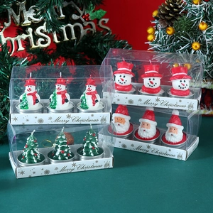 Close-up of Christmas candle set featuring snowman and tree shapes in a PVC gift box