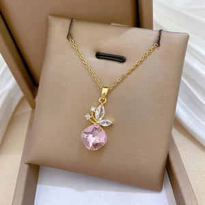 Elegant gold butterfly necklace with pink crystal pendant on luxurious silk background