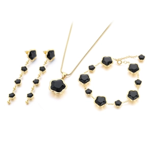 Elegant gold stainless steel jewelry set with black clover charms and tassel earrings