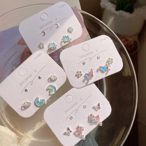 Iridescent butterfly and star earring set with 925 silver pins in a glass dish