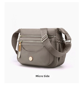 Detail view of water-resistant nylon shoulder bag with multiple zippered compartments