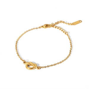 Detailed view of gold knot chain bracelet with adjustable lobster clasp and metal texture